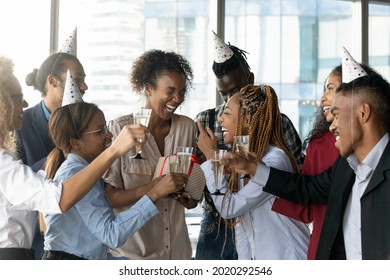 Overjoyed Candid Laughing African American Female Employee Getting Birthday Surprise Gift From Friendly Biracial Colleagues, Celebrating Happy Birthday, Enjoying Carefree Hangout Party In Office.