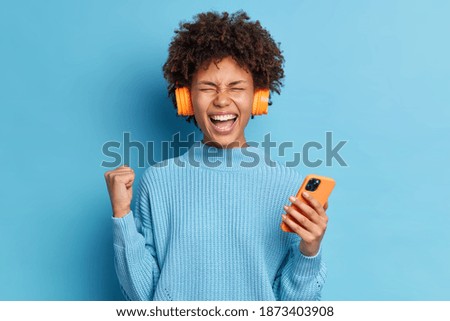 Similar – Image, Stock Photo A woman enjoying listening to music with her headphones