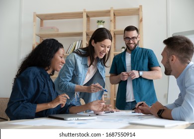 Overjoyed diverse businesspeople have fun engaged in creative thinking at team briefing in office, smiling multiracial colleagues laugh brainstorm discussing ideas at meeting, teamwork concept - Shutterstock ID 1687550914