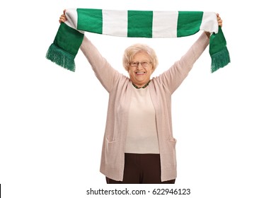 Overjoyed elderly football fan holding a scarf isolated on white background