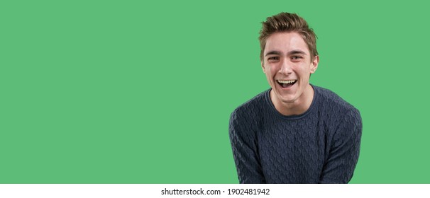 Overjoyed feels the euphoria of an online win, excited happy young guy, the concept of luck on a green background - Shutterstock ID 1902481942