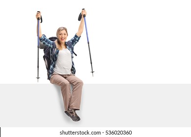 Overjoyed Female Hiker Sitting On A Panel Isolated On White Background