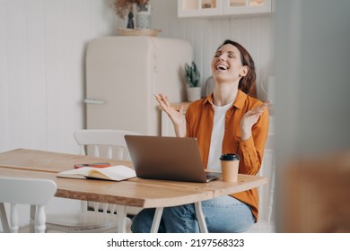 Overjoyed female rejoicing success, got email with good news online on laptop. Happy woman received promotion at work, celebrating achievement of goal, sitting at kitchen table at home. - Shutterstock ID 2197568323