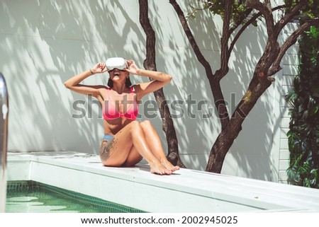 Similar – Surfer woman with top and bikini holding surfboard