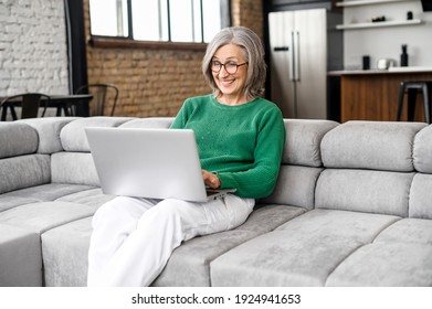 Overjoyed Happy Middle Aged 60s Mature Woman In Eyeglasses Looking At Laptop Screen, Reading Email With Amazing News, Celebrating Online Lottery Win, Getting Bank Loan Approval Or Money Refund