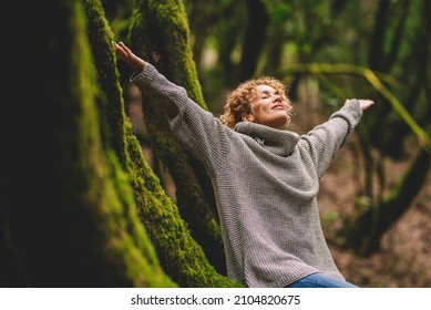 Overjoyed happy woman enjoying the green beautiful nature woods forest around her - concept of female people and healthy natural lifestyle - happiness emotion and adult lady opening arms  - Shutterstock ID 2104820675