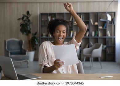 Overjoyed Laughing Young African American Woman Holding Paper Correspondence Letter, Celebrating Getting Good News, Admission Bank Statement, Dream Job Offer, Loan Approval, Excellent Test Results.