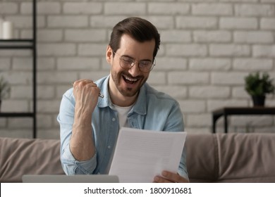 Overjoyed millennial Caucasian man read postal paper correspondence triumph celebrate job promotion, happy young male feel excited euphoric with good news on post letter paperwork, success concept - Shutterstock ID 1800910681