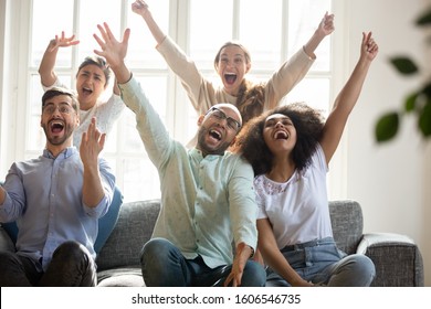 Overjoyed millennial multiracial friends gather at home watching football online feel euphoric celebrating victory, excited happy multiethnic young people triumph enjoying sports game win together - Shutterstock ID 1606546735