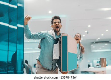 Overjoyed Multicultural Couple Holding Box With New Plasma Tv. Tech Store Interior.