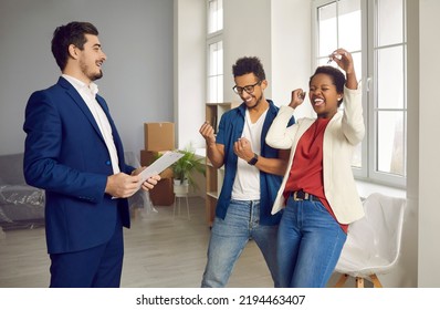 Overjoyed Multiracial Couple Buyers Celebrate Deal Buy First House From Real Estate Agent. Broker Or Realtor Give Keys To New Home To Happy Customers Congratulate With Ownership. Realty Concept.