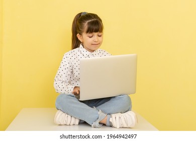 Overjoyed school girl with laptop. Online lesson video call. Kid listen teacher. Distance study in comfort room indoors. 
