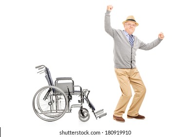 Overjoyed Senior Adult Standing Up From A Wheelchair Isolated On White Background