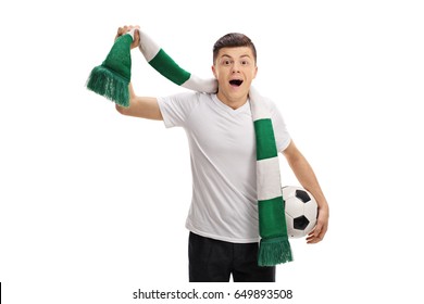 Overjoyed Teenage Soccer Fan With A Scarf And A Football Isolated On White Background