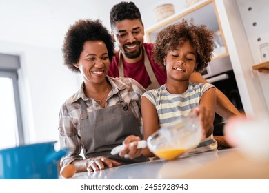 Overjoyed young african american family with kid have fun cooking at home together, - Powered by Shutterstock