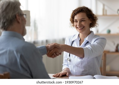 Overjoyed young Caucasian female doctor shake hand greet get acquainted with senior male patient in hospital consultation. Smiling woman GP handshake old man close health insurance deal in clinic. - Powered by Shutterstock