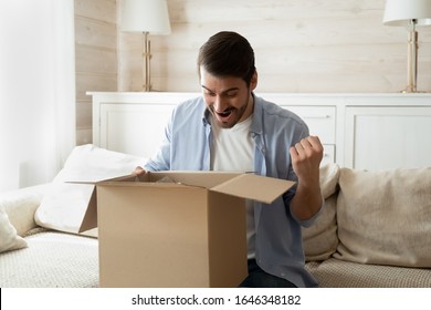 Overjoyed Young Caucasian Male Client Feel Excited With Good Quality Order Unpack Box At Home Shopping Online, Happy Man Customer Triumph Receive Package Buy In Internet, Delivery Service Concept