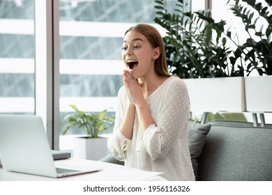 Overjoyed young female employee or worker look at computer screen surprised by good business news online. Happy excited Caucasian businesswoman triumph read about financial success on laptop. - Shutterstock ID 1956116326