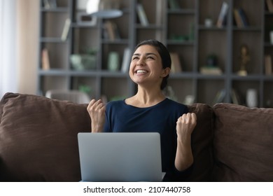 Overjoyed young Indian woman celebrating getting good news, reading email with unbelievable win news, feeling excited of received dream job offer, online lottery gambling win, internet success concept