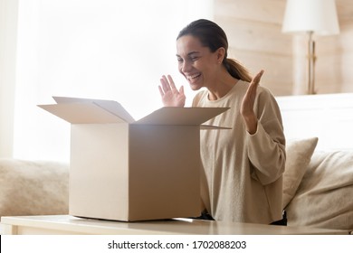 Overjoyed Young Mixed Race Woman Opening Carton Box, Purchase From Online Store. Happy Female Client Satisfied With Fast Delivery Service, Unpacking Cardboard Parcel, Internet Shopping Concept.