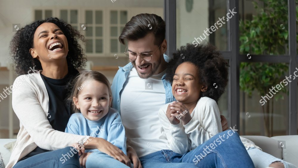 Overjoyed young multiracial family with two small daughters relax on ...