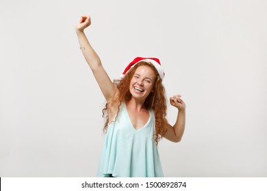 Overjoyed young redhead Santa girl in light clothes, Christmas hat isolated on white background in studio. Happy New Year 2020 celebration holiday concept. Mock up copy space. Doing winner gesture - Shutterstock ID 1500892874