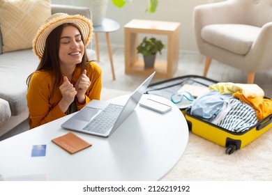 Overjoyed young woman booking hot tour online, excited over huge sale in tourist agency, using laptop to book hotel or buy plane tickets on discount from home, free space. Abroad travel concept