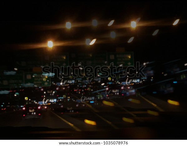 The overlay of the car image on the\
street dark and blurred night,  Night traffic, cars on highway\
road,  Overlapping images blurry ,chaingmai thailand.\
