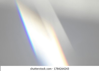 Overlay Effect For Photo And Mockups. Organic Drop Diagonal Shadow And Ray Of Light With Rainbow From Window On A White Wall.