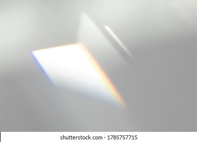 Overlay Effect For Photo And Mockups. Organic Drop Diagonal Shadow And Ray Of Light With Rainbow From Window On A White Wall.