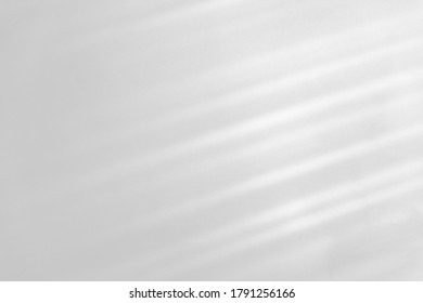 Overlay effect for photo and mockups. Organic drop diagonal shadow and rays of light from window on a white wall. shadows for natural light effects