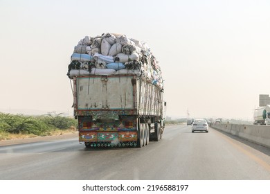 overload truck running on the road and could dangerous for other vehicle  - Shutterstock ID 2196588197