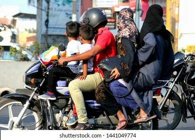 overloaded bike Five members of a Indian family travelling by motorcycle. risky motorbike traveling. 