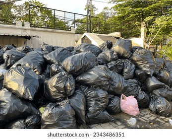 Premium Photo  Pile of plastic garbage bags near the tree garbage