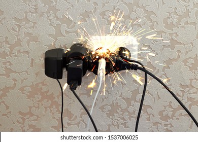 Overloaded socket, spark. Danger of electric shock, fire. Wire, plug, fire.