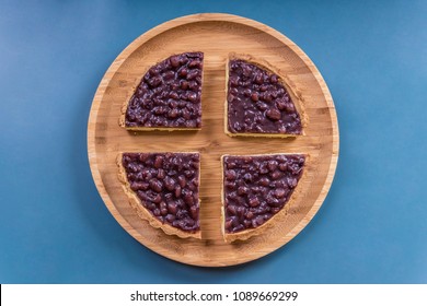 Overlook The Red Bean Pies On The Round Wooden Plate With Navy Blue Background