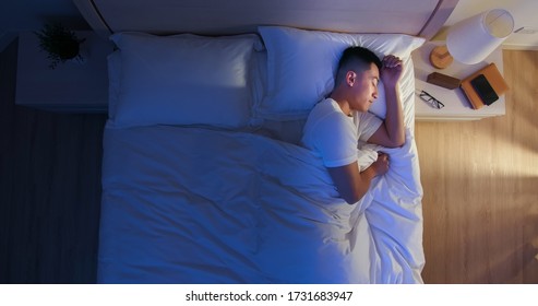 Overlooking Of Asian Man Sleep Well With Smile At Night 