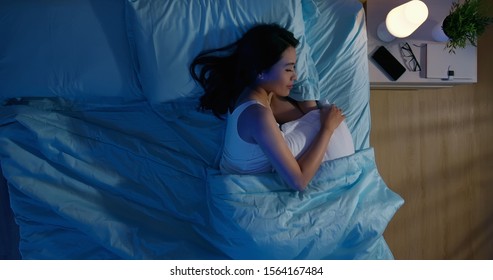 overlooking of asian woman sleep well with smile at night  - Shutterstock ID 1564167484