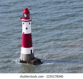 Overlooking the beachy head lighthouse, stood alone in the rough seas, bright and colourful it stands out in the bleak colours of the water. 