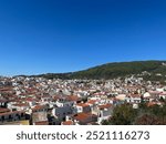 Overlooking the beautiful island town in Skiathos Greece overlooking the ocean with blue skies