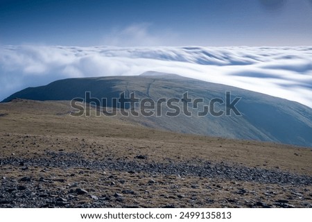 Overlooking a cloud inversion from the summit of Helvellyn in the Lake District National Park