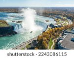 Overlooking the Niagara Falls Horseshoe Falls in a sunny day in autumn foliage season. Niagara Falls City, Ontario, Canada.