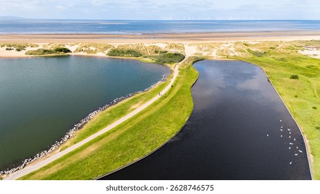 Overlooking the two lakes and path facing out to Crosby beach and the Irish Sea near Liverpool.