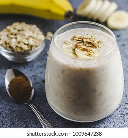 Overnight Oat Banana Smoothie In Glass On Concrete Background. Selective Focus, Space For Text. 