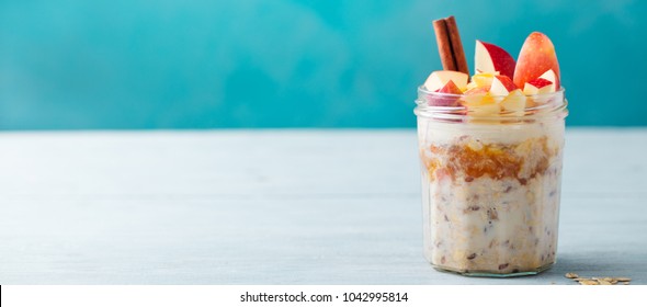 Overnight Oats, Bircher Muesli With Apple, Cinnamon And Honey. Blue Wooden Background. Copy Space.