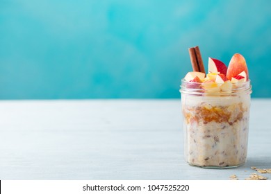 Overnight Oats, Bircher Muesli With Apple, Cinnamon And Honey. Blue Background. Copy Space.