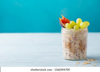 Overnight Oats, Bircher Muesli With Grape And Figs. Blue Background. Copy Space.