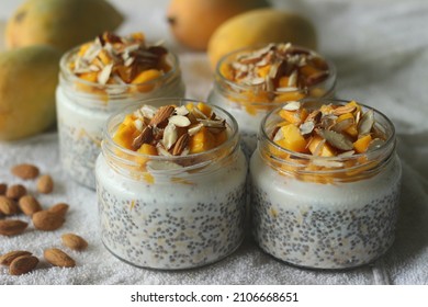 Overnight Oats With Mango And Almonds. Made By Soaking Rolled Oats And Chia Seeds In Milk Served With Chopped Mangoes, Almonds And Honey For A Chilled, Yummy, Healthy And Easy Breakfast.