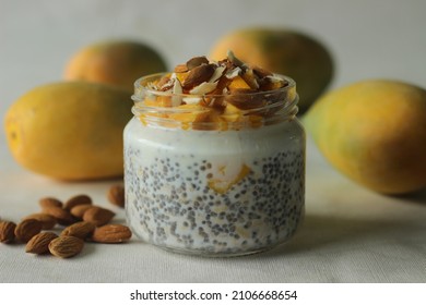 Overnight Oats With Mango And Almonds. Made By Soaking Rolled Oats And Chia Seeds In Milk Served With Chopped Mangoes, Almonds And Honey For A Chilled, Yummy, Healthy And Easy Breakfast.