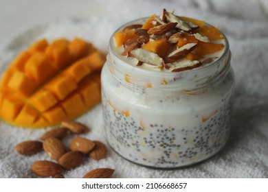 Overnight Oats With Mango And Almonds. Made By Soaking Rolled Oats And Chia Seeds In Milk Served With Chopped Mangoes, Almonds And Honey For A Chilled, Yummy, Healthy And Easy Breakfast.